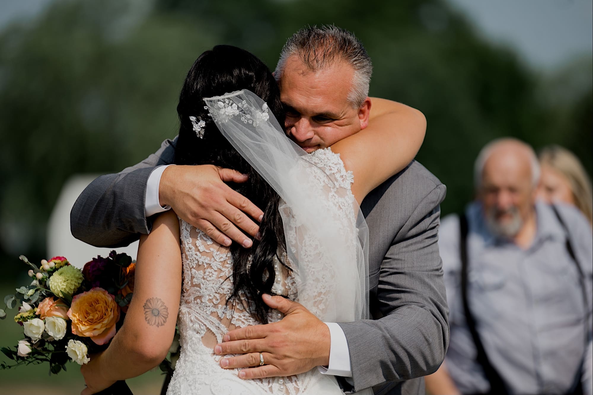 bride hugging her father carper winery wedding ceremony