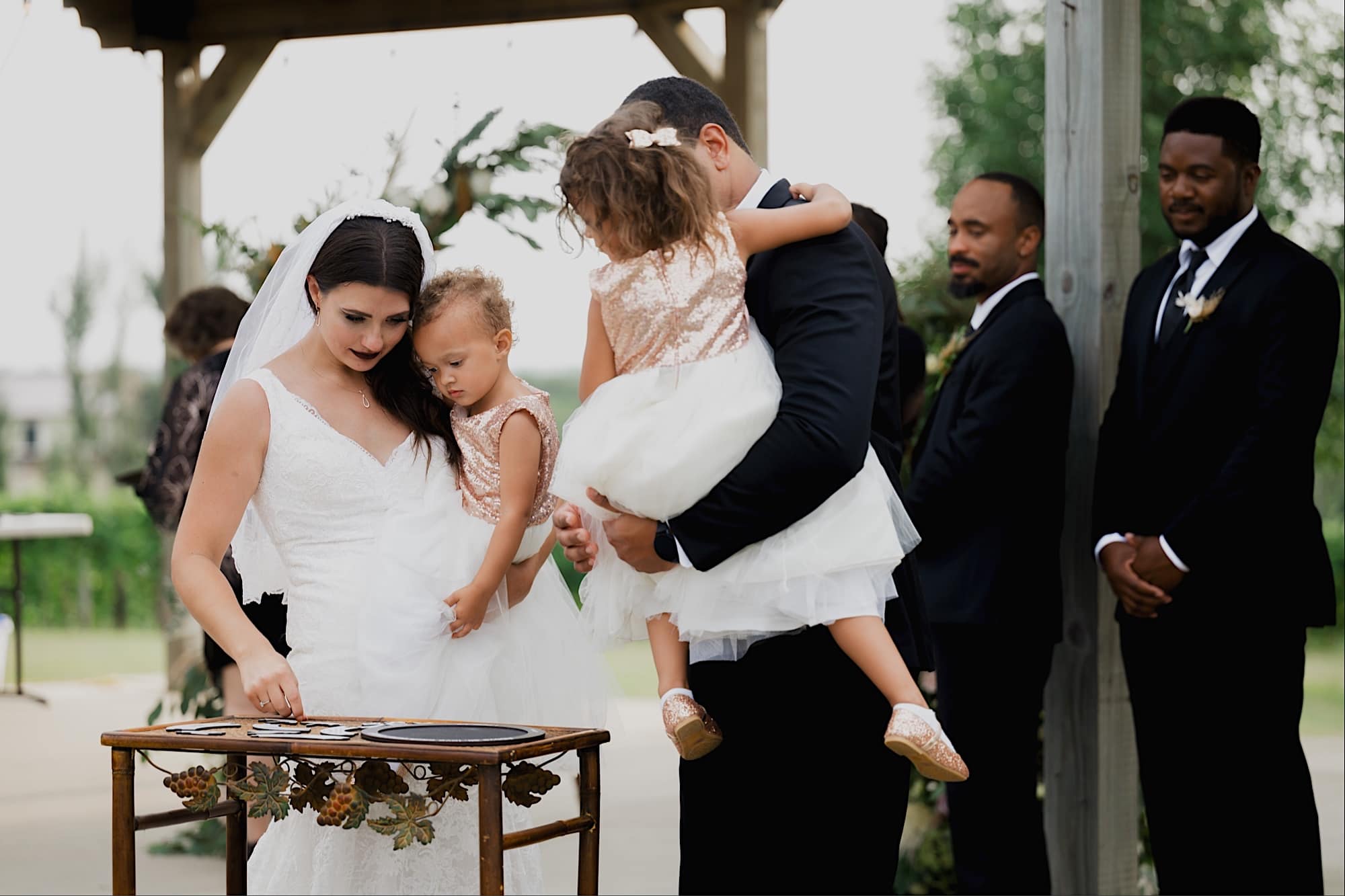 bride and groom with daughters at fireside winery wedding