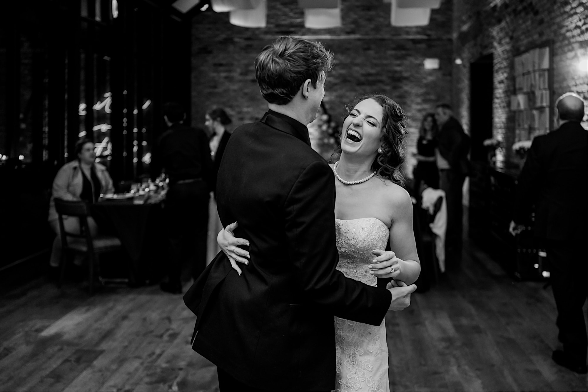 bride and groom laughing at surety hotel wedding reception