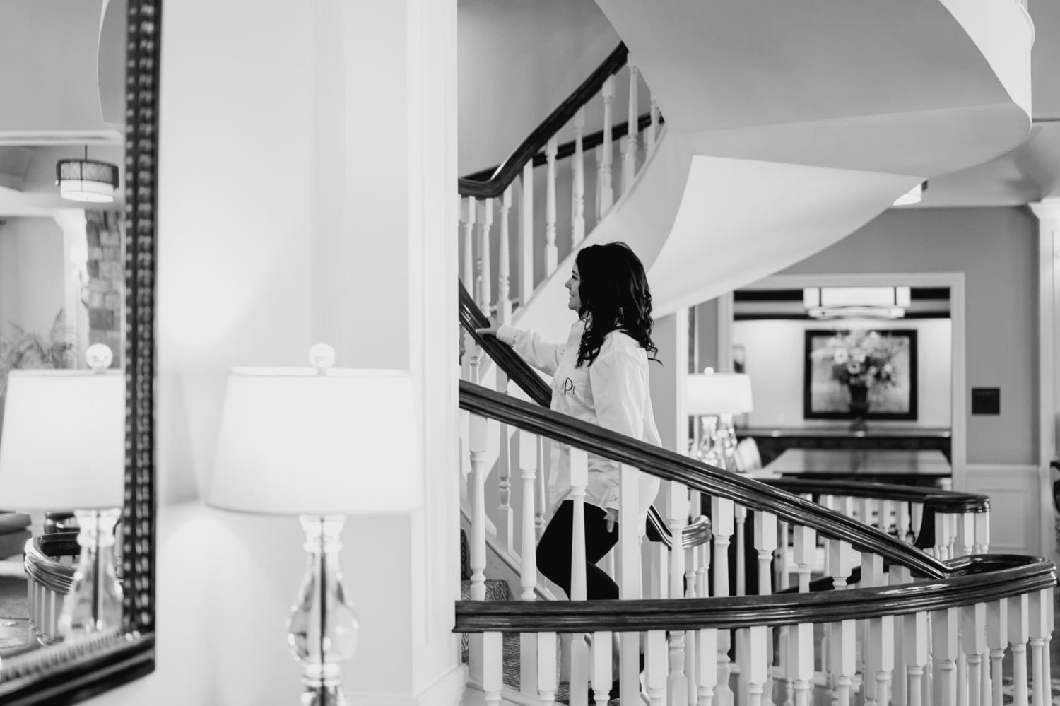 Bride walking up spiral staircase at Glen Oaks country club Des Moines Iowa