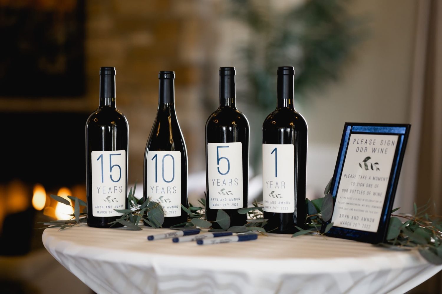 Anniversary wine bottles for guests to sign at a wedding