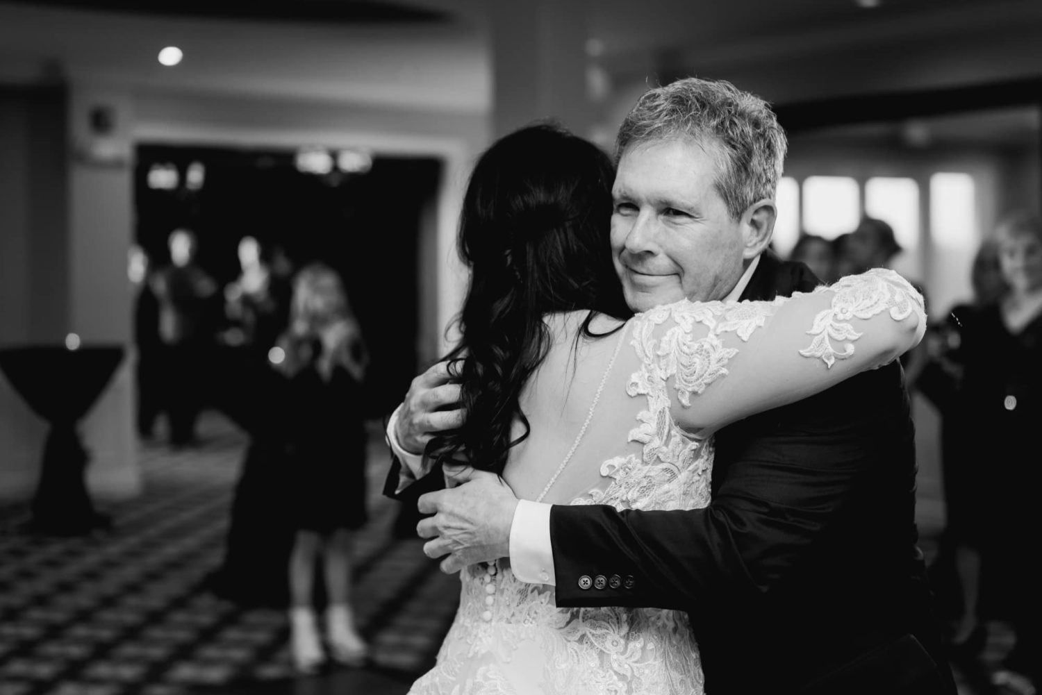 Father of the bride hugging bride after their father daughter dance