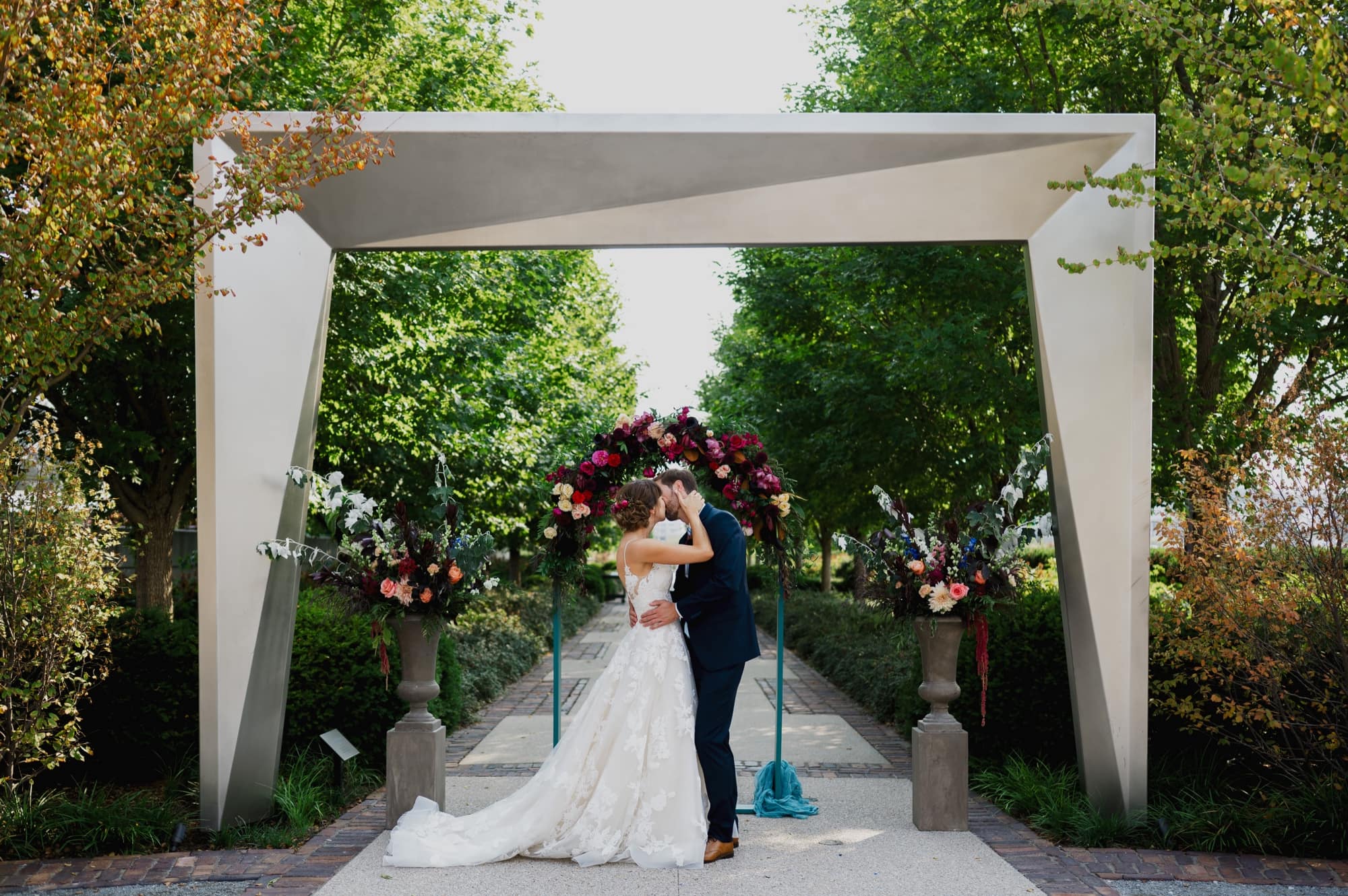 Bride and groom kissing outdoor ceremony at the greater Des Moines botanical Garden