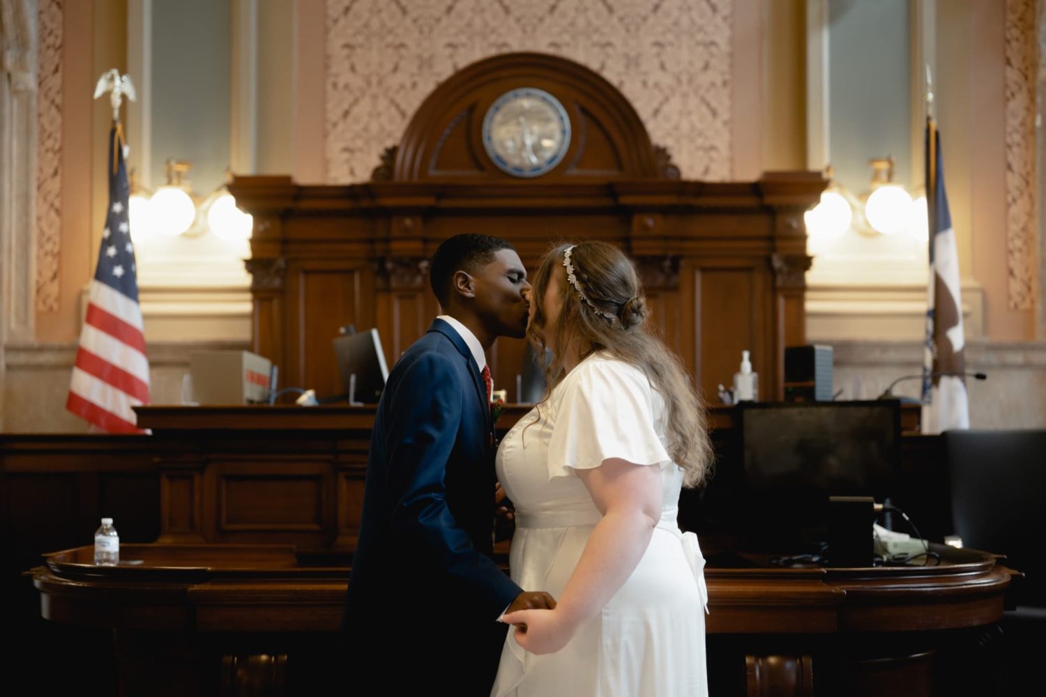 Bride and groom first kiss at a courthouse wedding