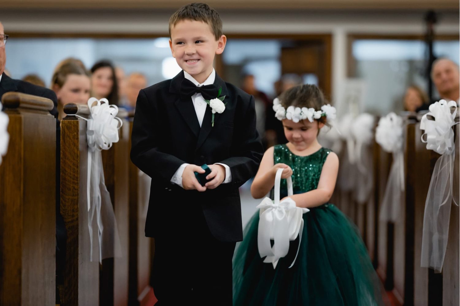 Ringbearer and flower girl walking down the aisle at the Westminster Presbyterian Church in Des Moines Iowa