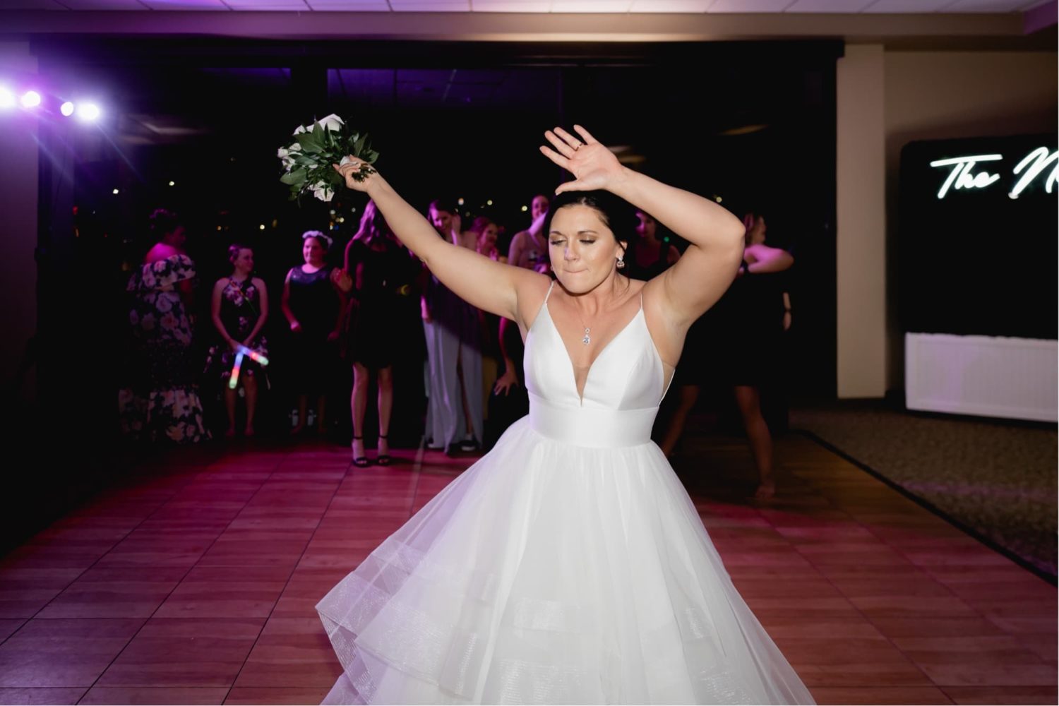 Bride getting ready to toss her bouquet on the dance floor