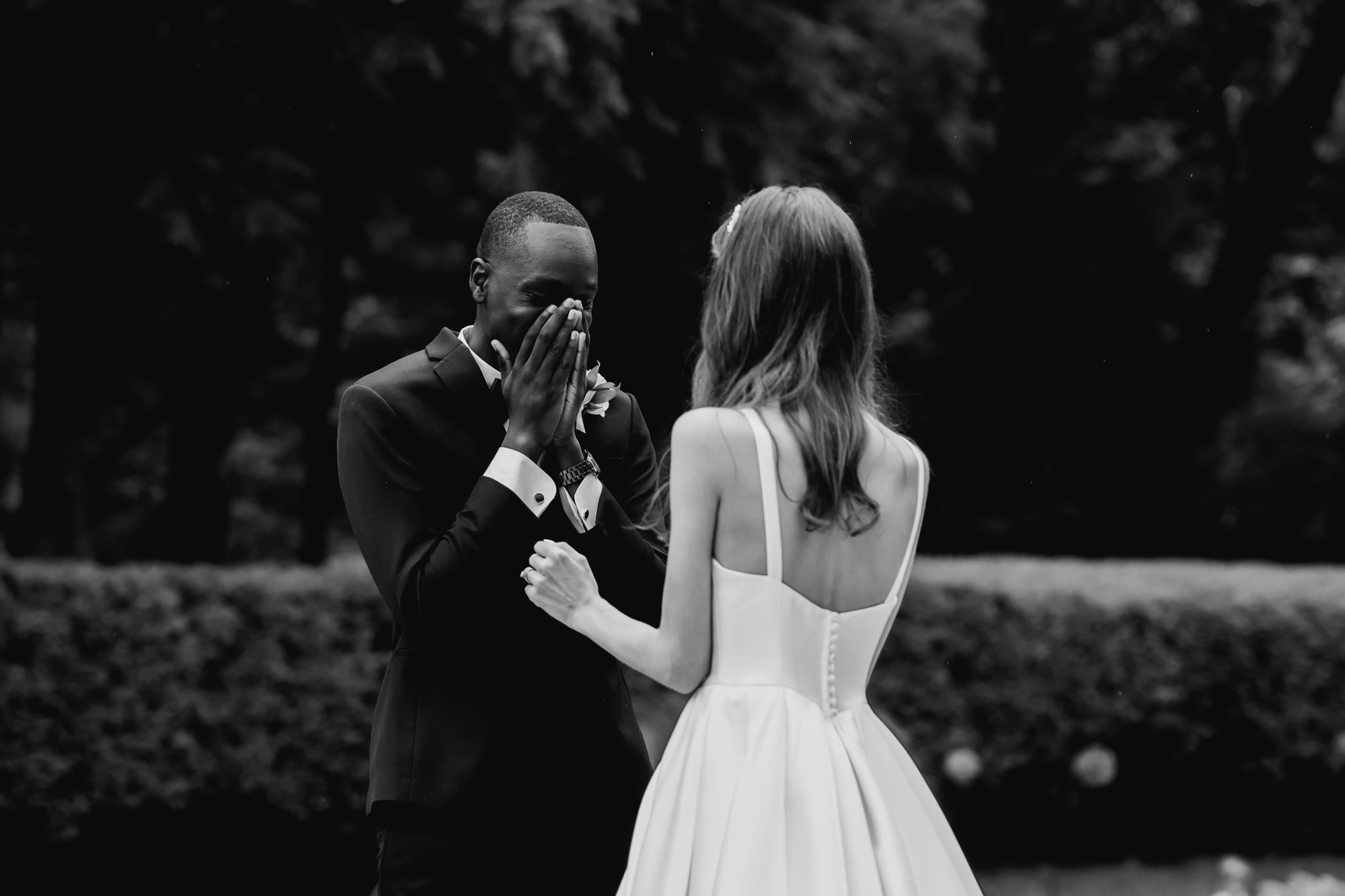 Groom in awe of his bride during the first look