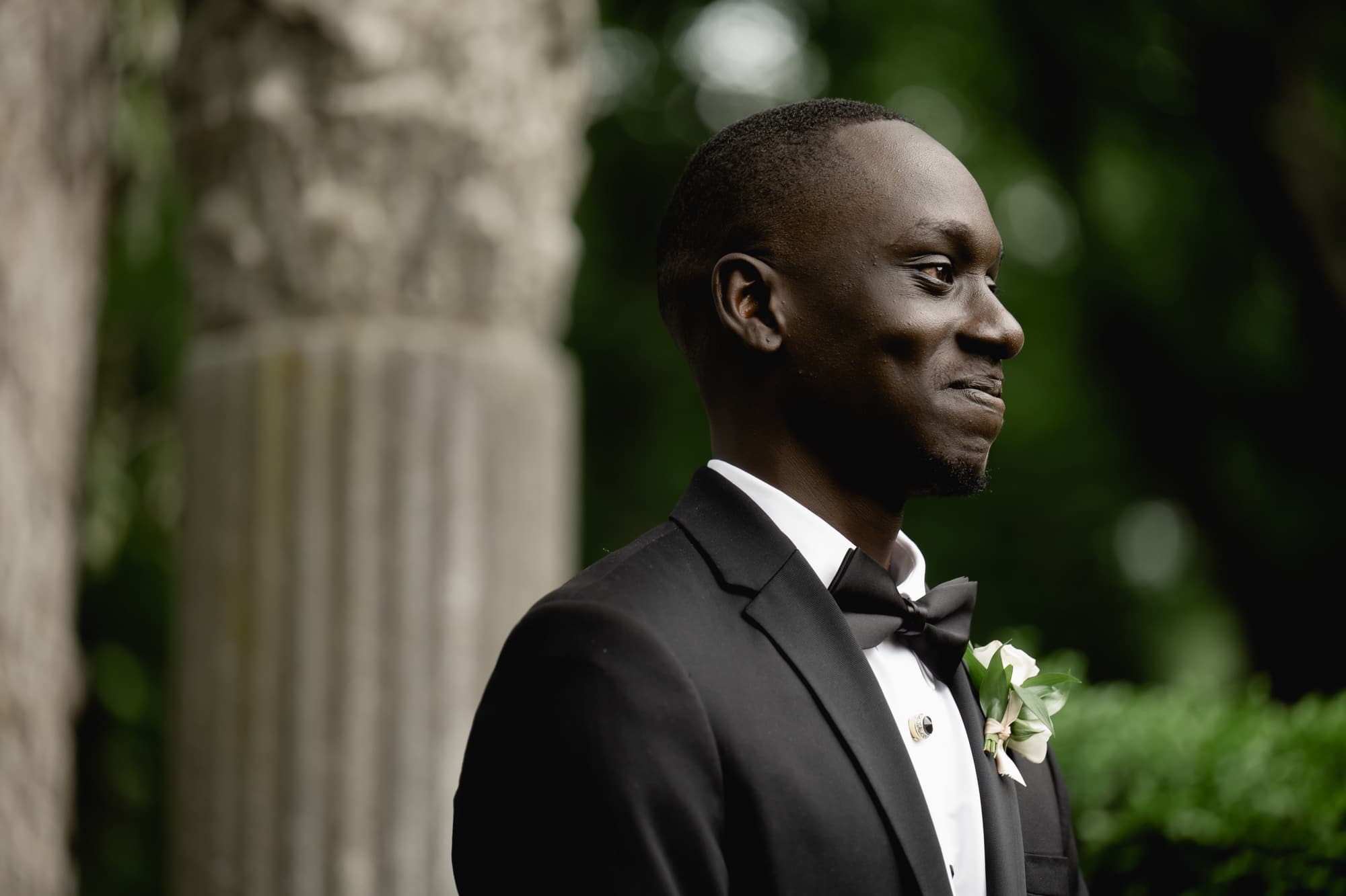 Groom smiling at bride as she walks down the aisle