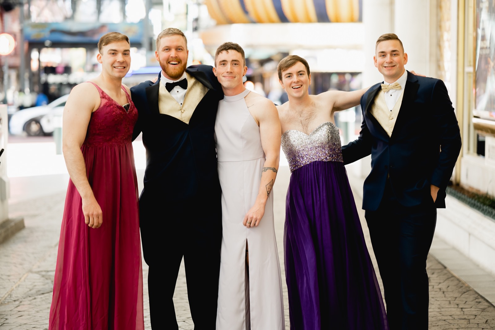 Groom with groomsmen in bridesmaid dresses