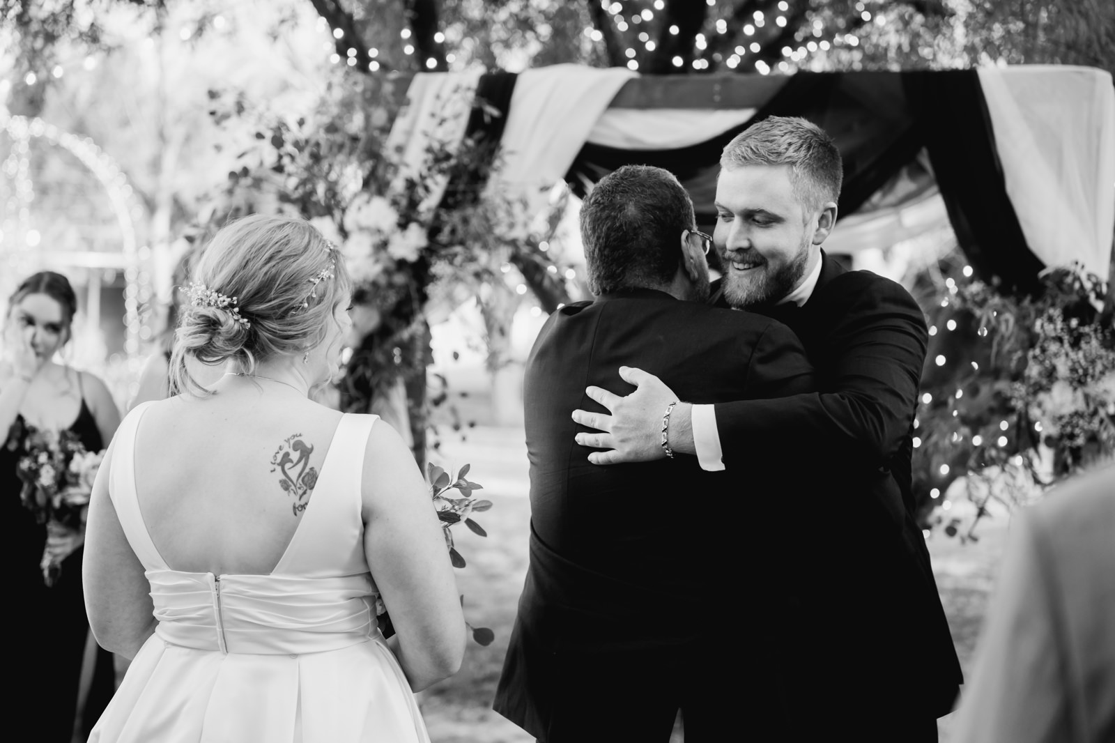 Groom hugging the father of the bride