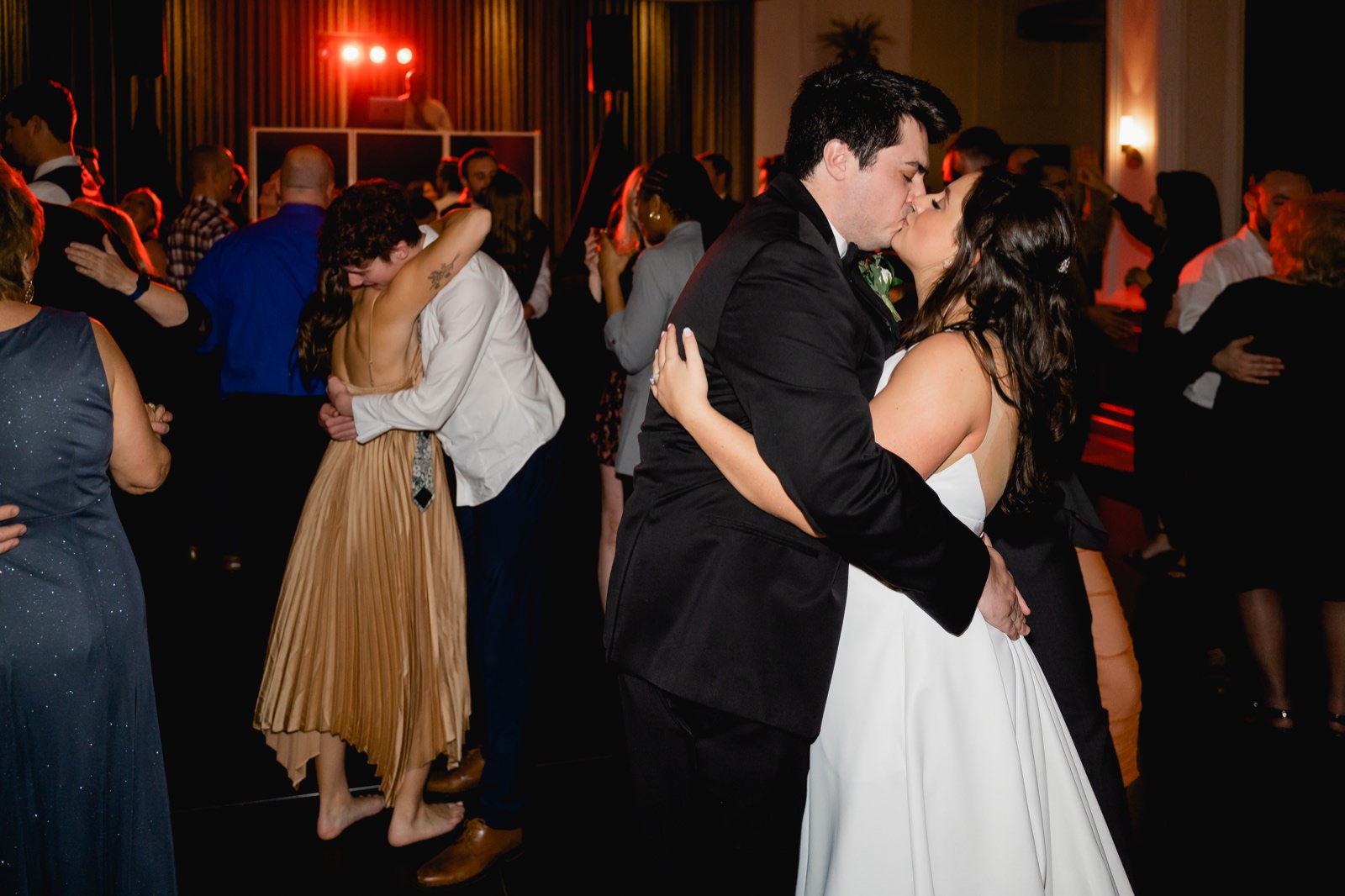 bride and groom kissing on the dance floor end of night