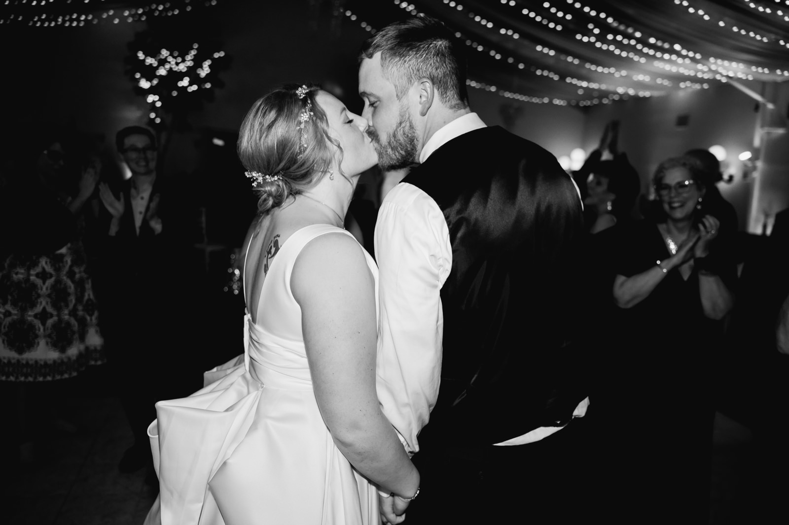 Bride and groom kissing at the end of the night at secret garden wedding menu