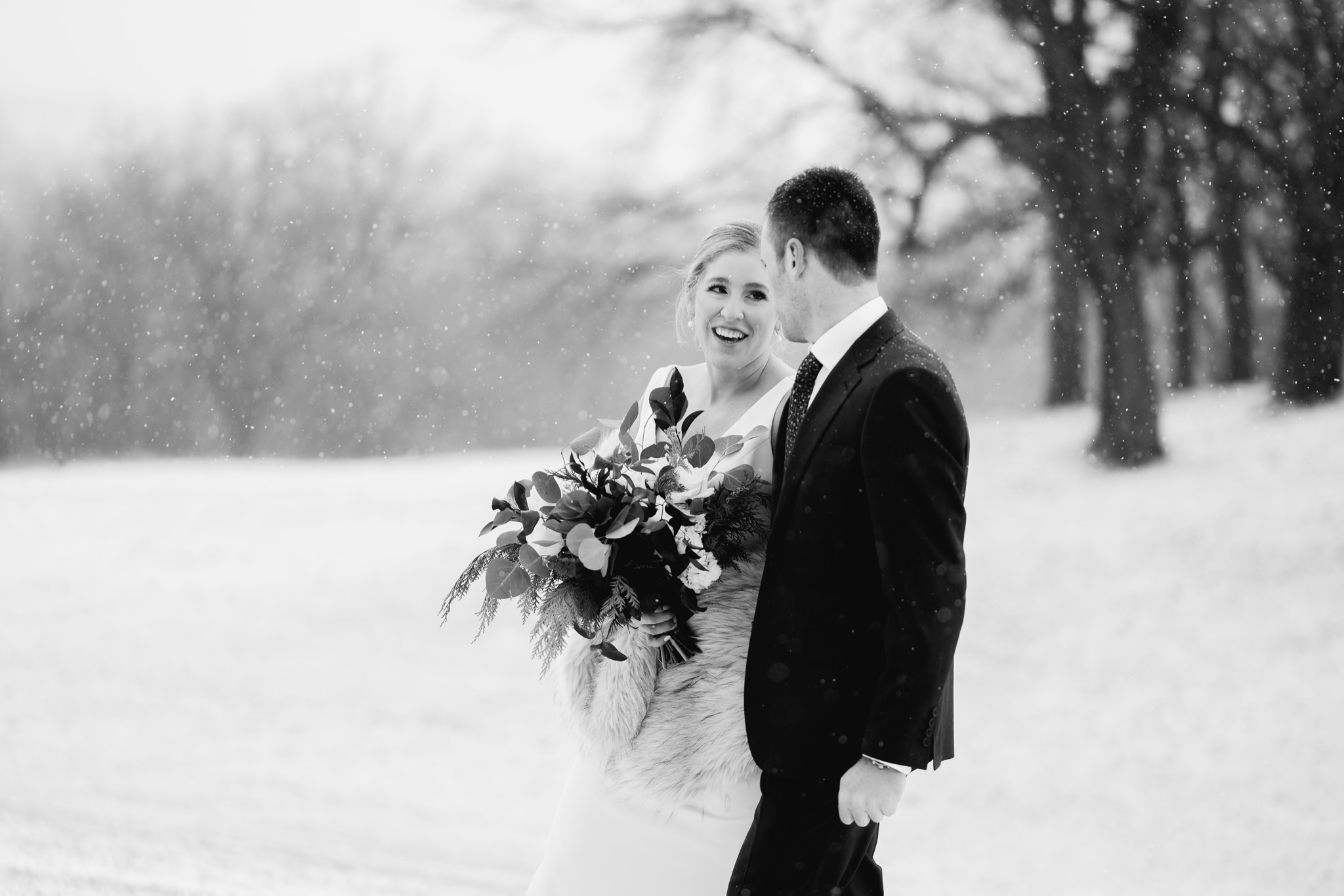 bride and groom walking in the snow