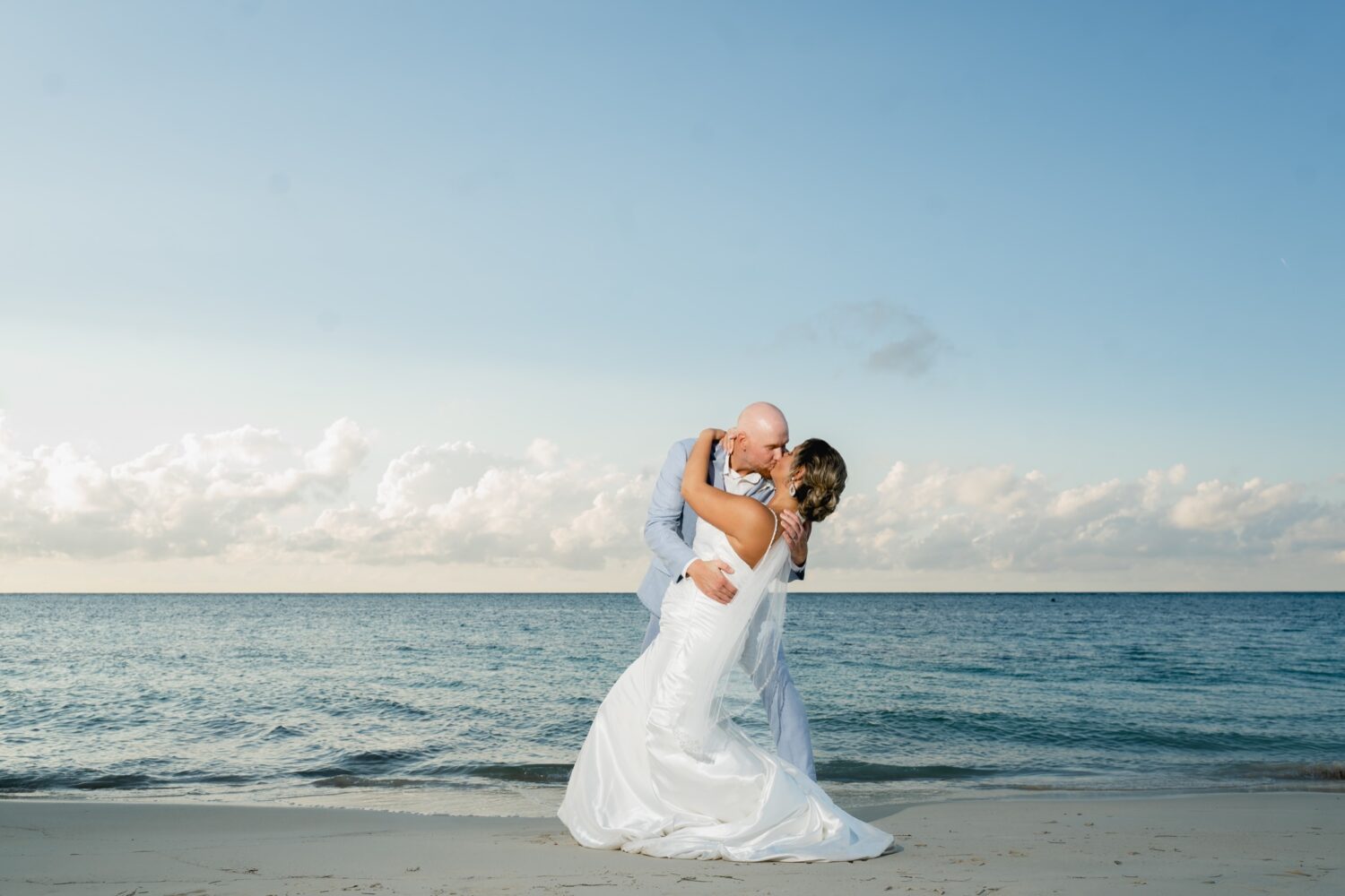 bride and groom kissing in the caribbean