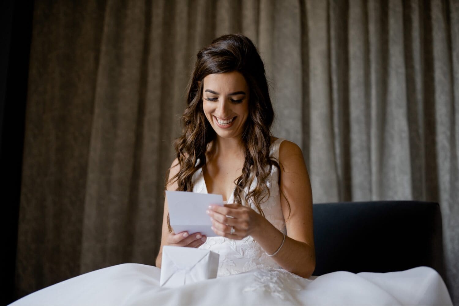 bride reading a letter from her husband on their wedding day