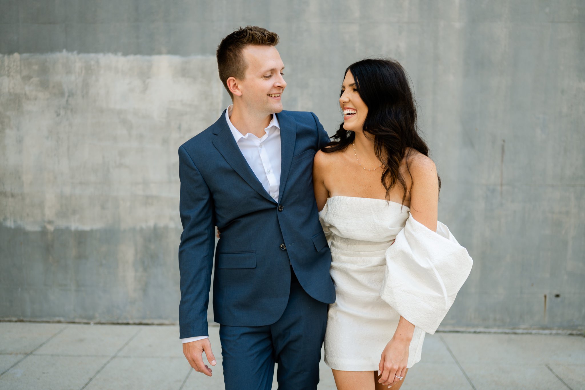 bride and groom laughing in engagement photos