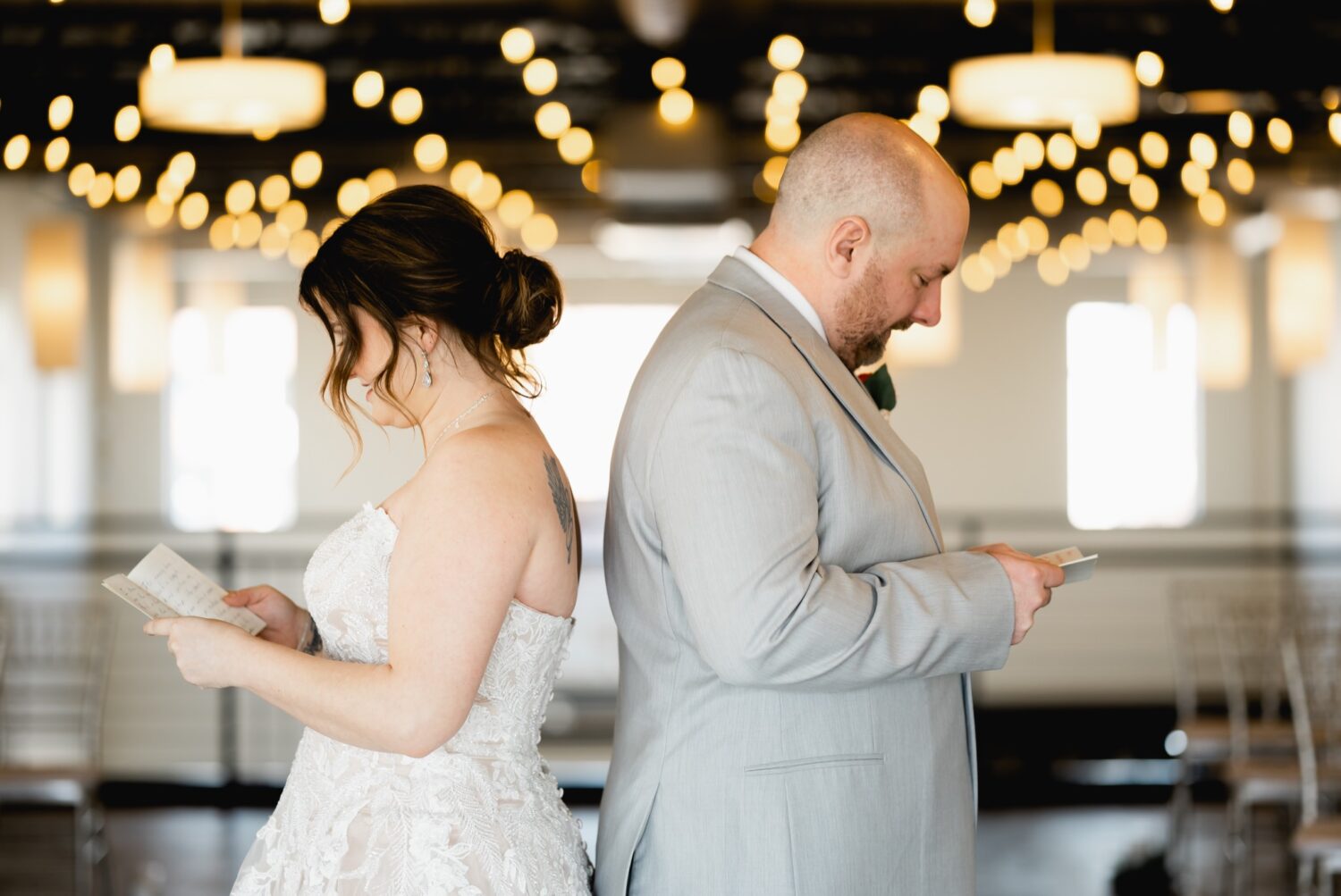 couple reading vows at district venue ankeny wedding