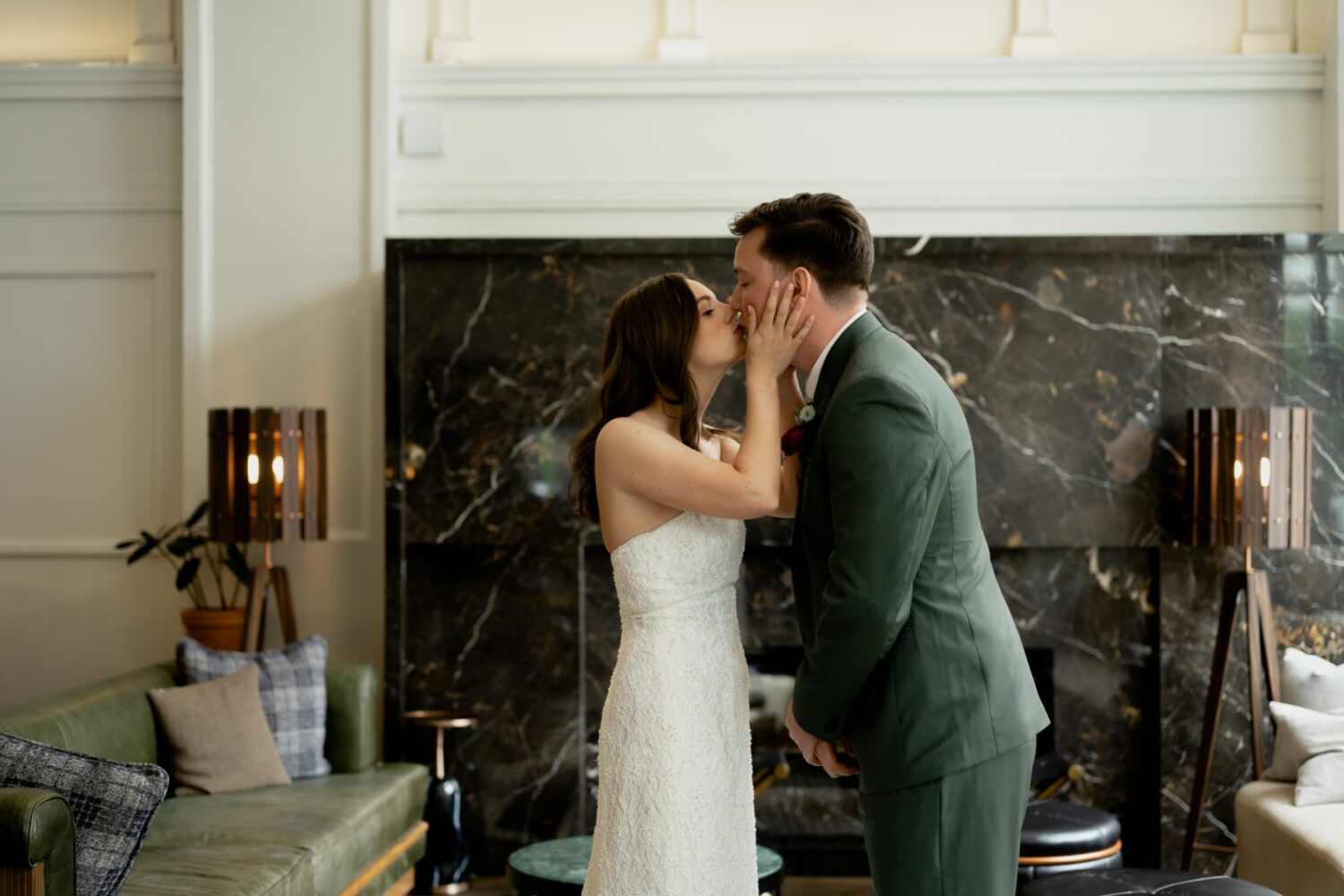 bride and groom kissing in the lobby at Surety Hotel