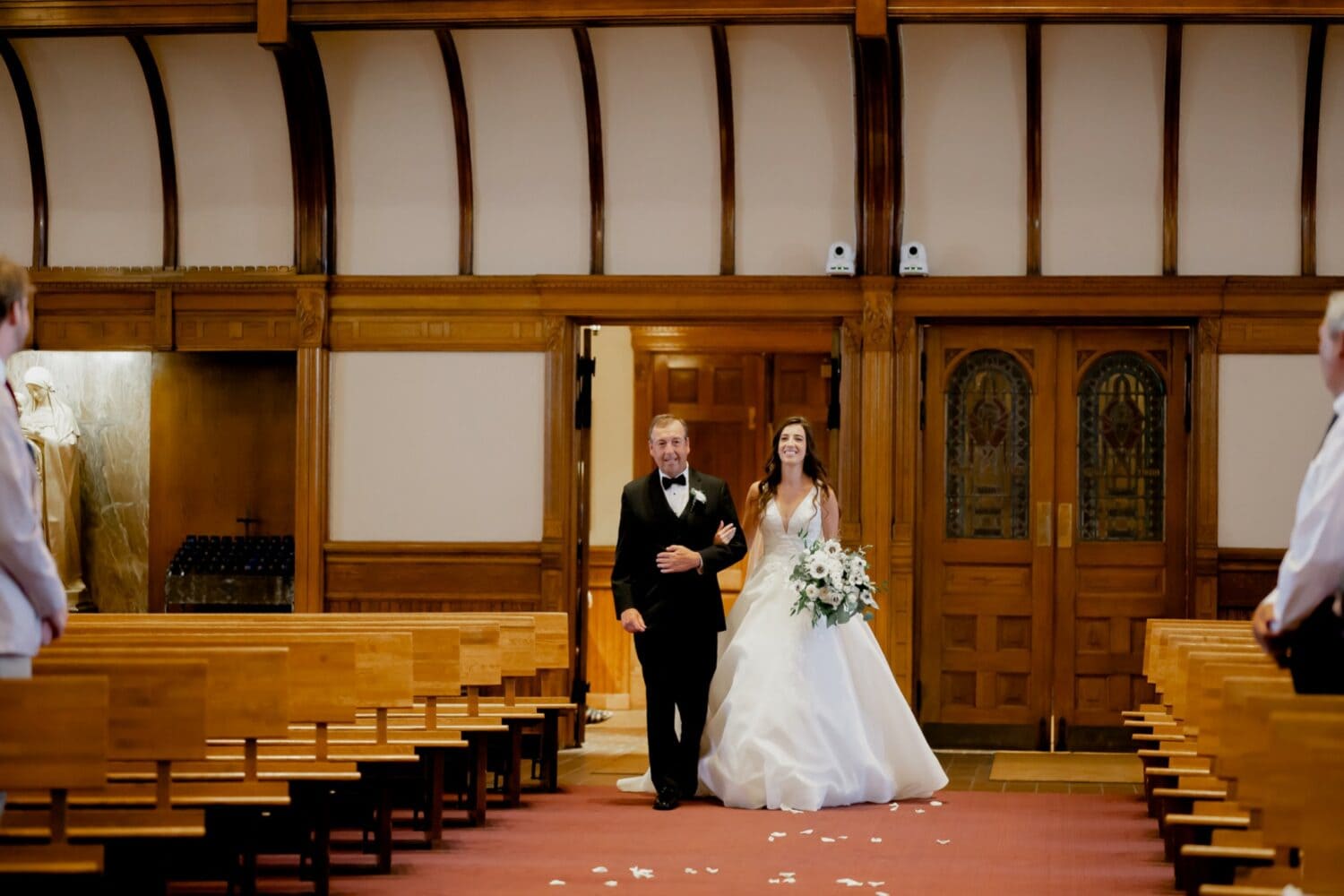 bride and her father walking down the aisle at st ambrose cathedral