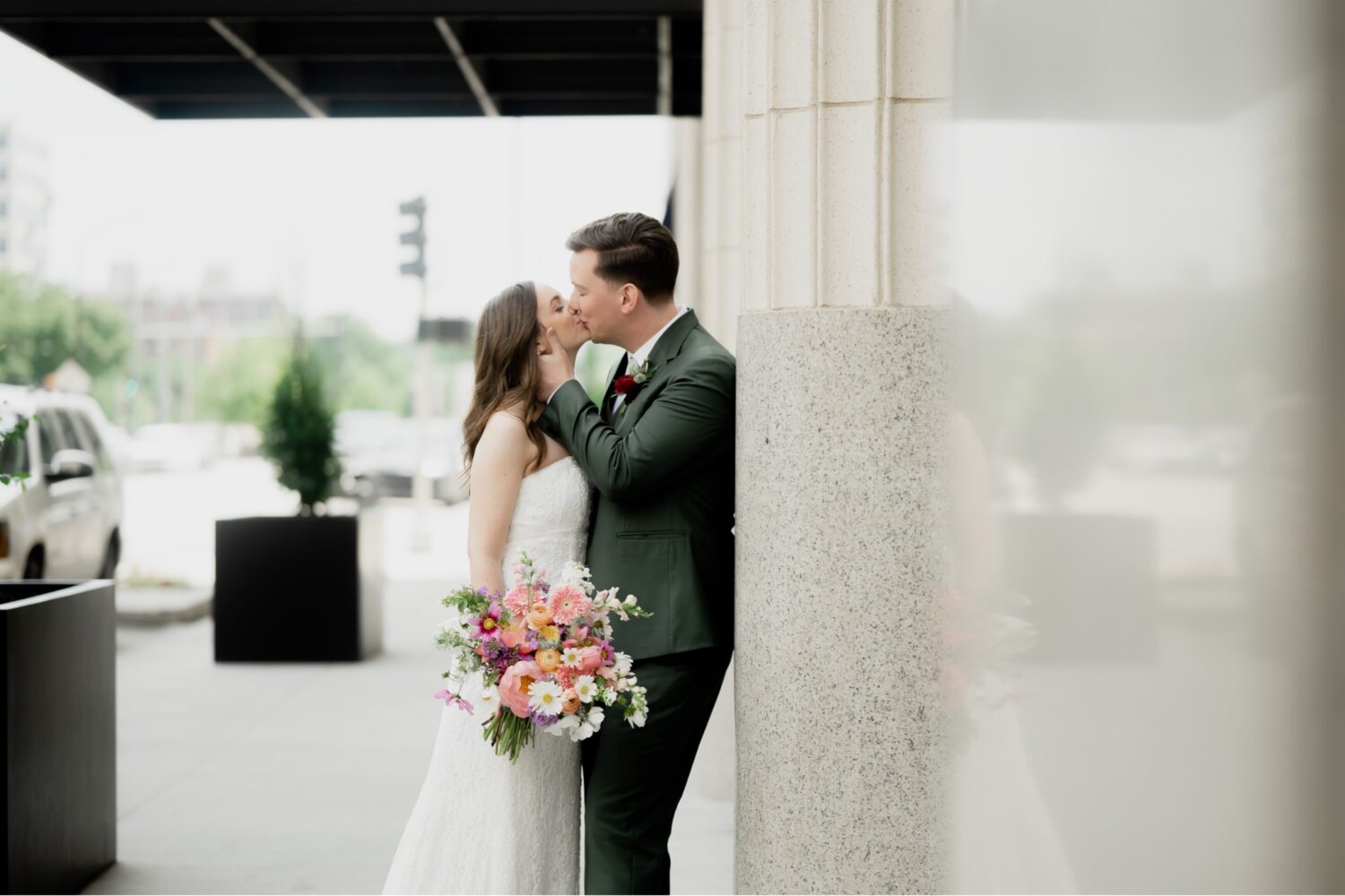 bride and groom kissing outside surety hotel des moines iowa