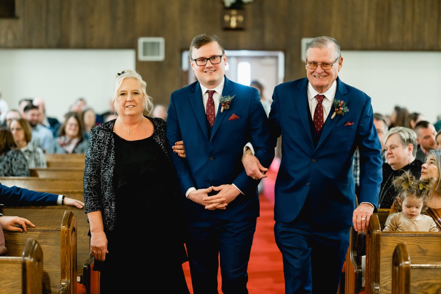groom walking parents down the aisle