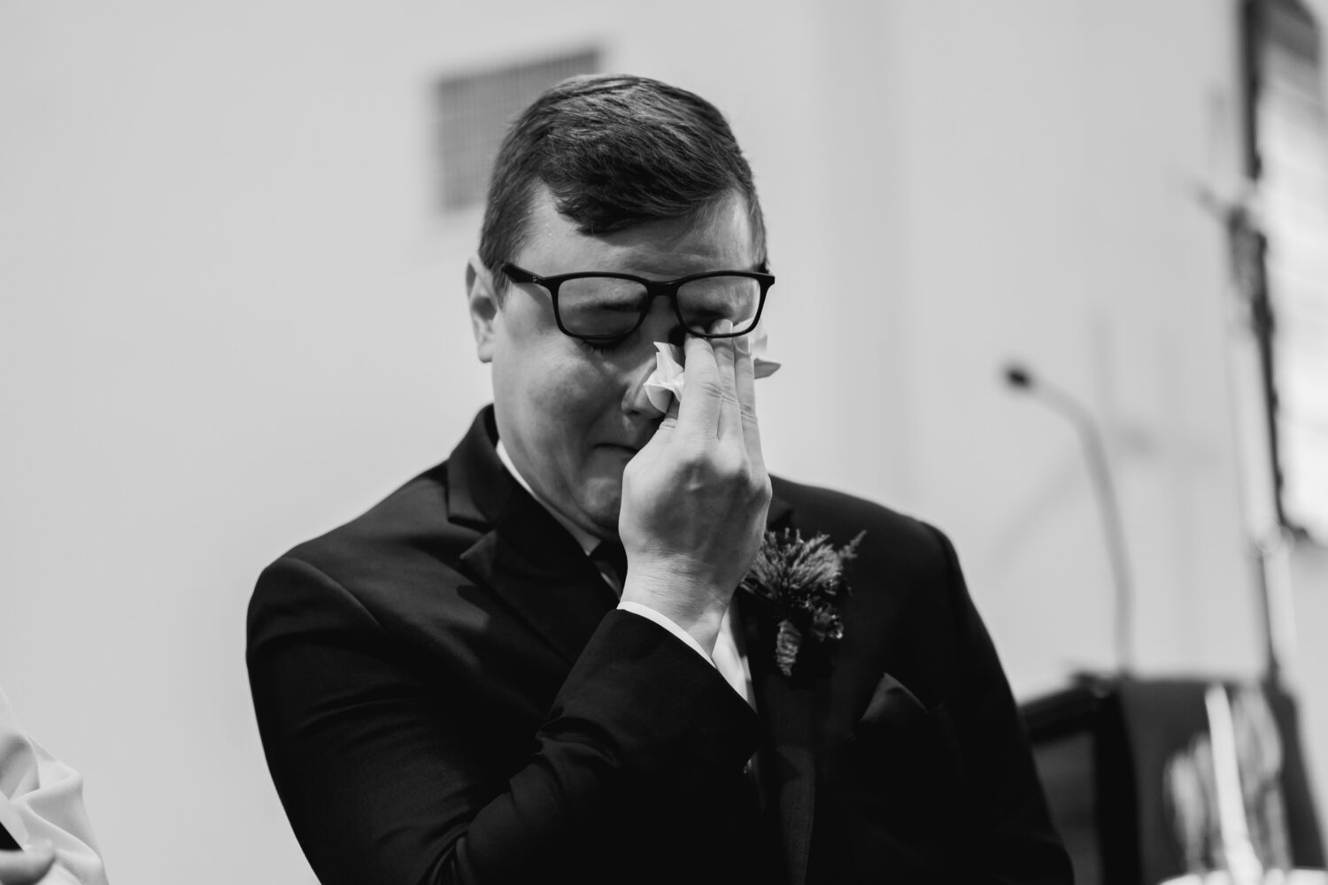 groom crying as the bride walks down the aisle