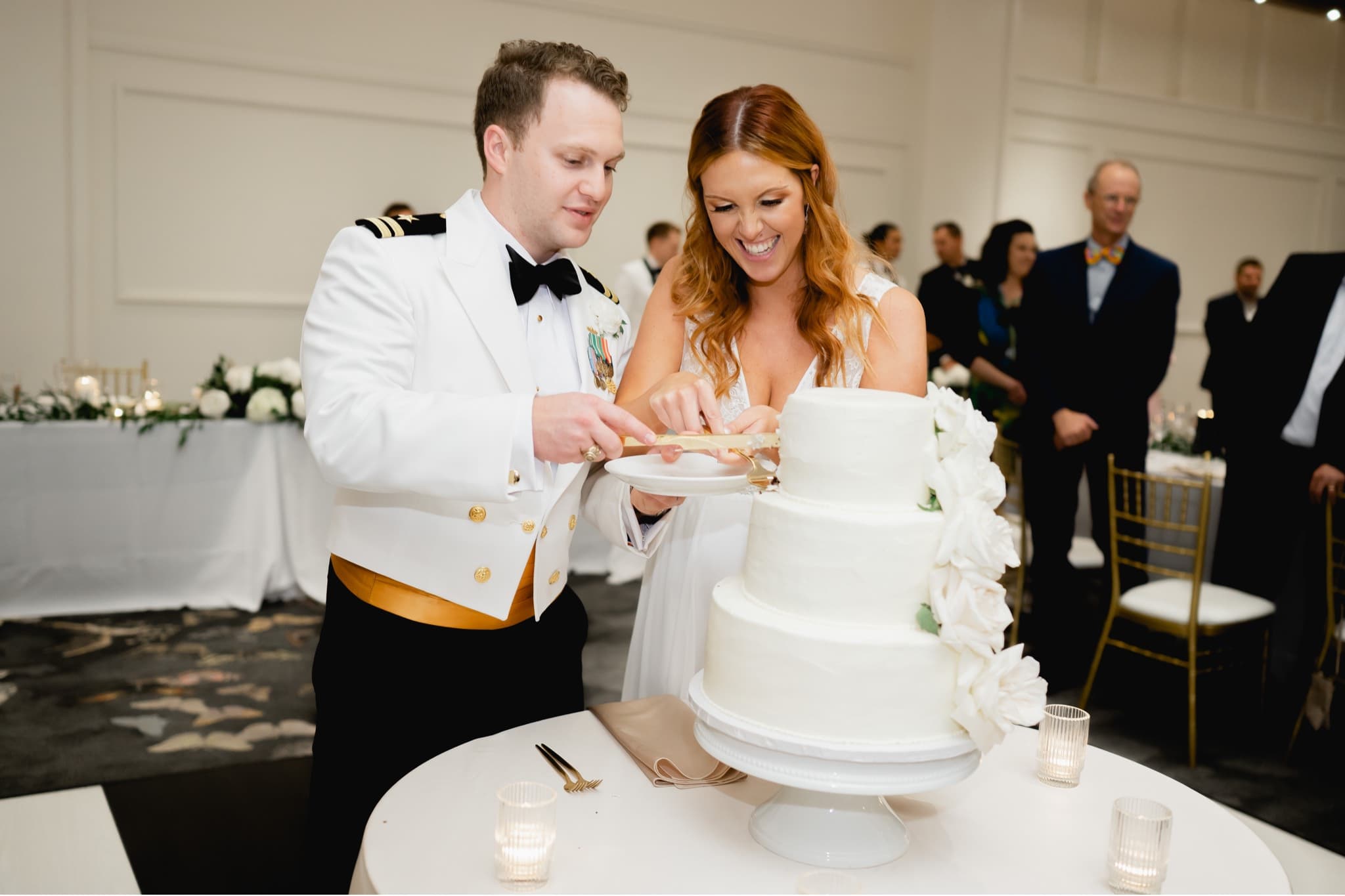 bride and groom cutting the cake at surety hotel wedding