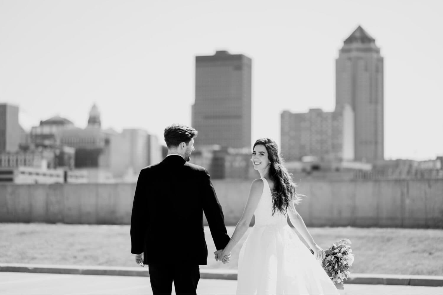 bride and groom classic portraits with des moines skyline