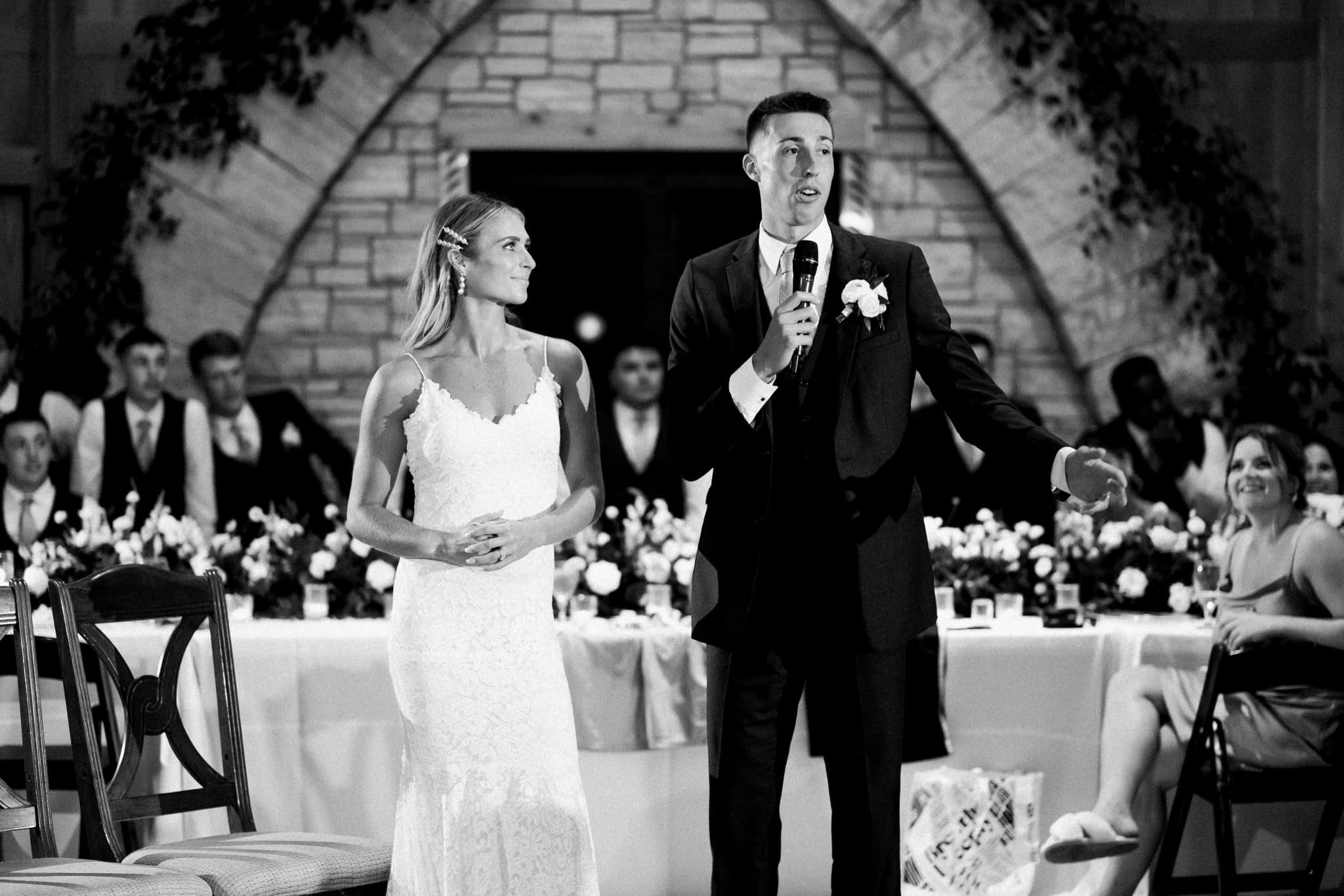 groom giving speech at wedding reception