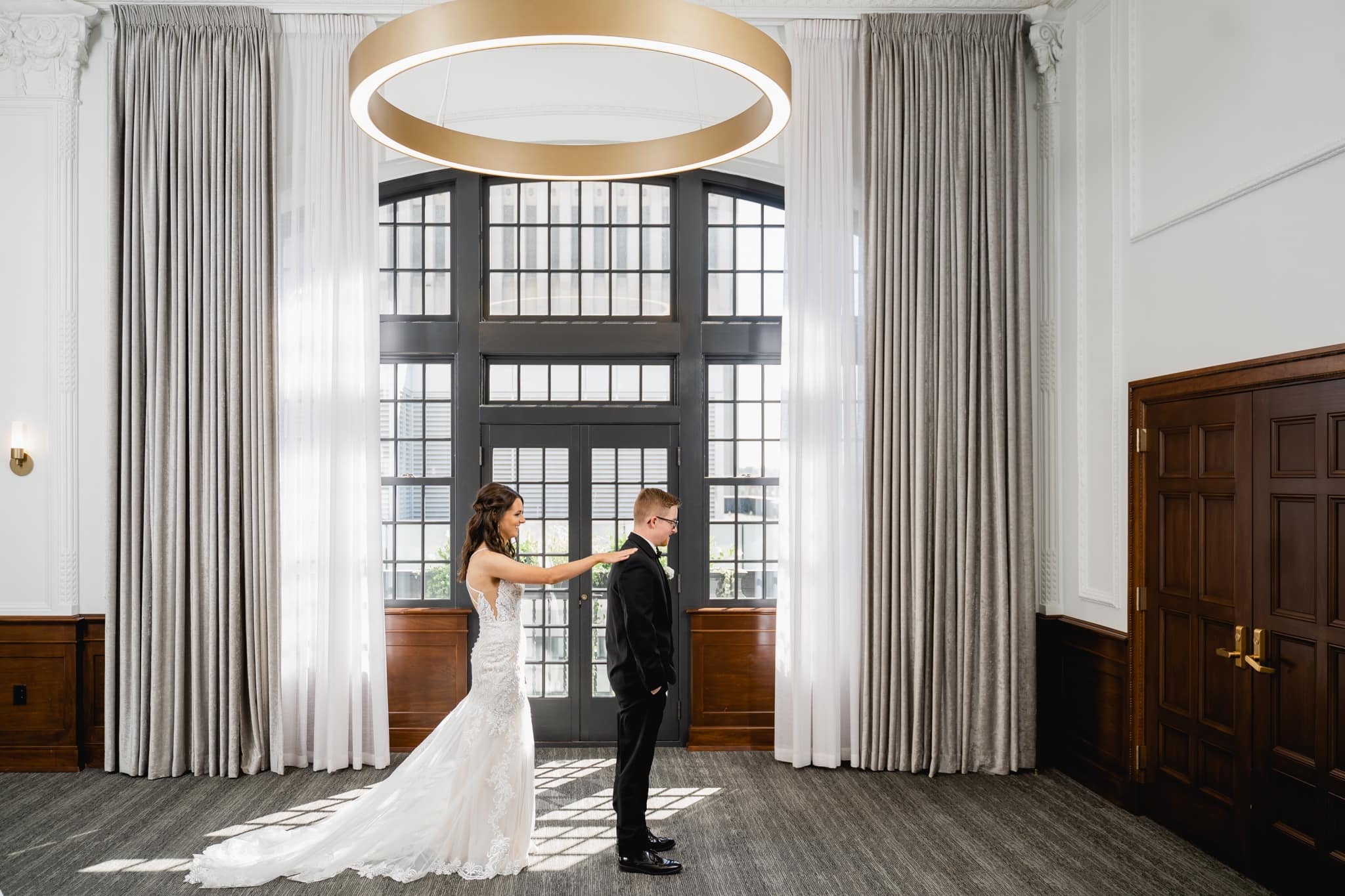 bride and groom first look at the tea room wedding venue in des moines iowa