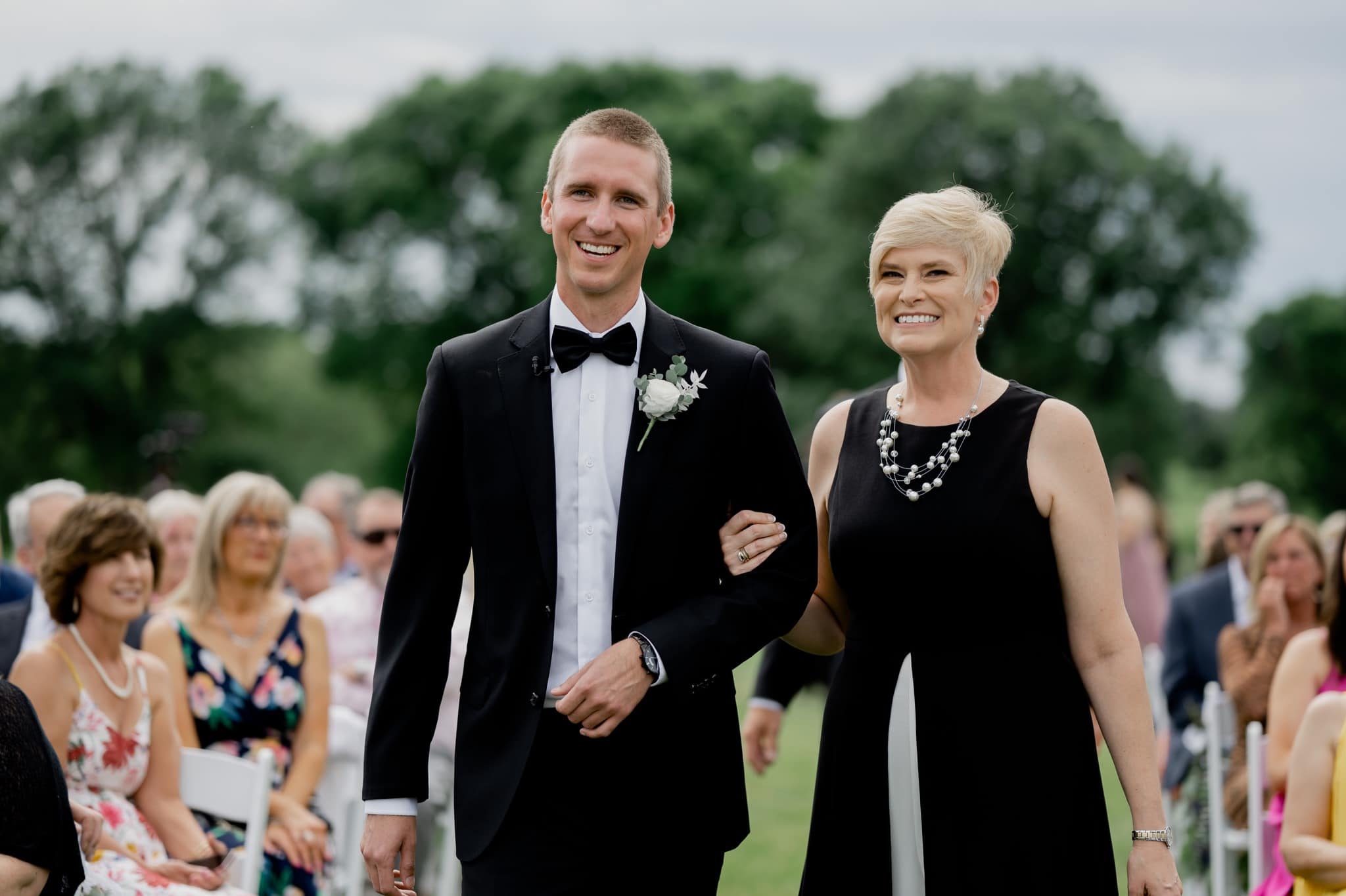 bride walking mother down aisle at Des Moines Golf and Country Club wedding