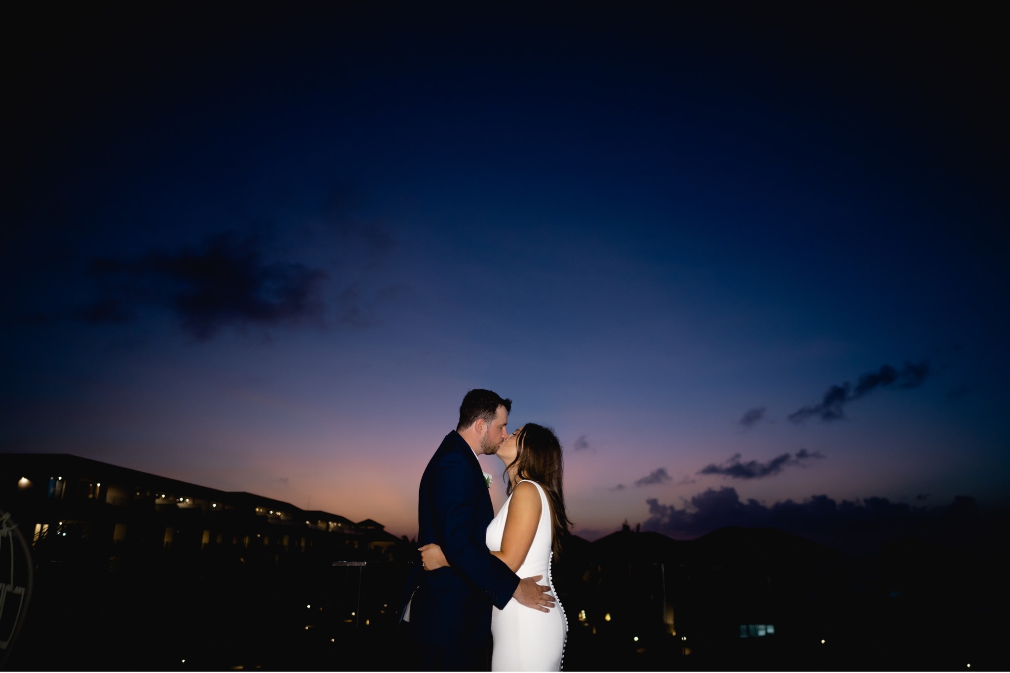 bride and groom kissing sunset in jamaica