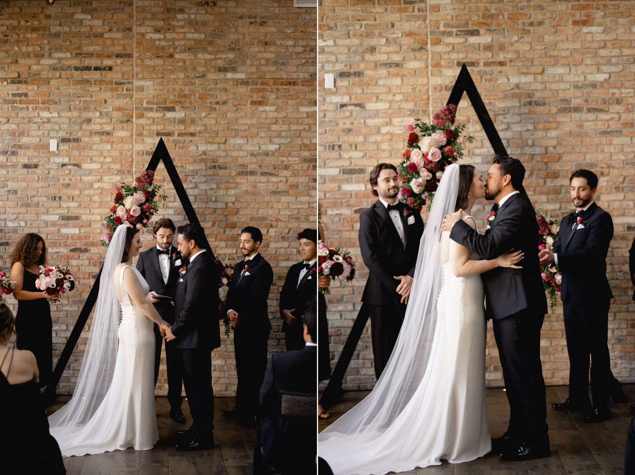 bride and groom first kiss at surety hotel wedding ceremony