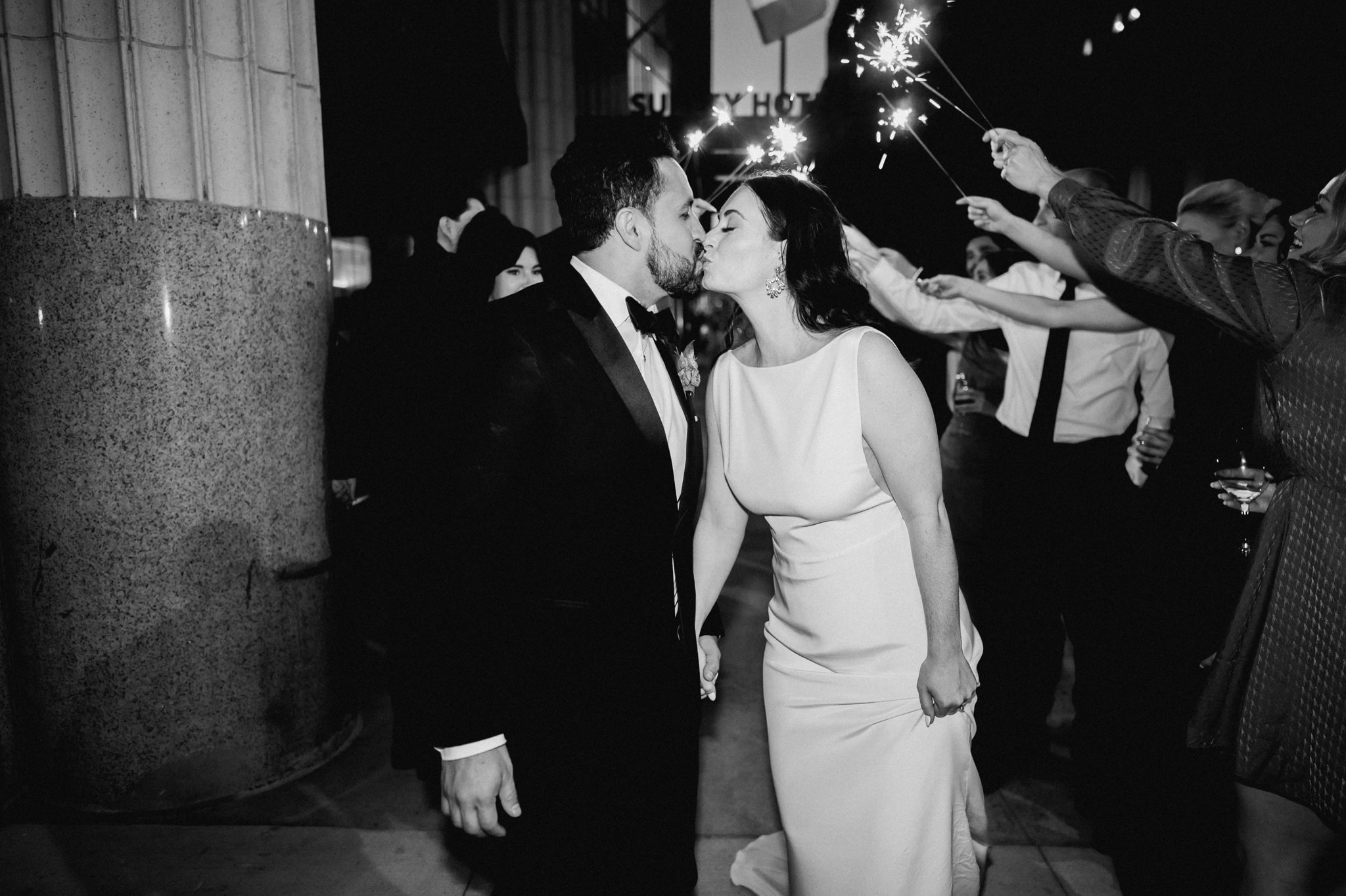 bride and groom end of night kiss during sparkler exit at surety hotel wedding