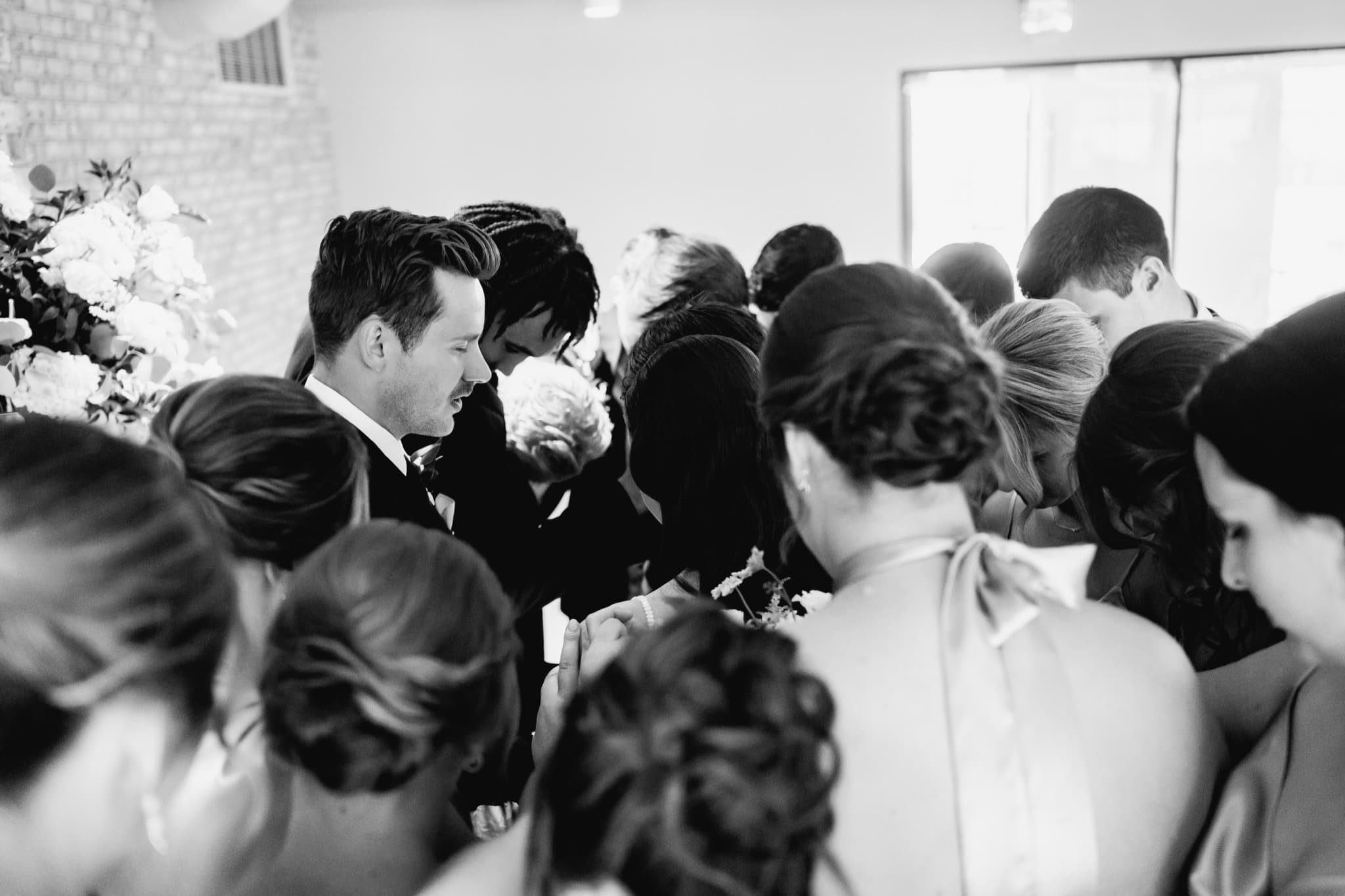 group prayer during wedding ceremony