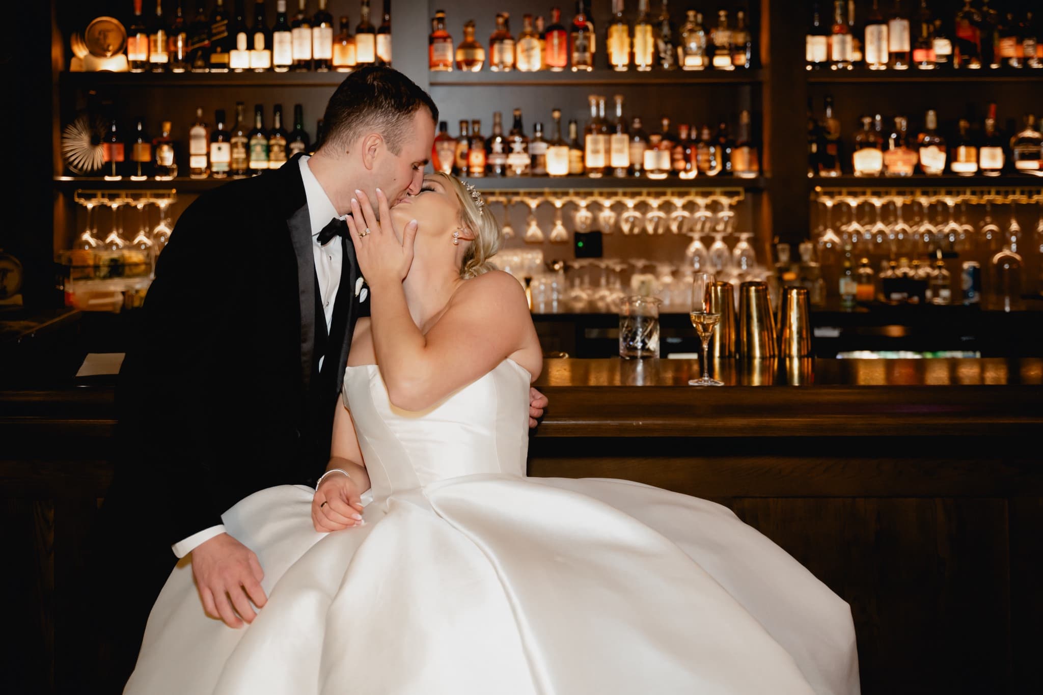 bride and groom kissing in a speakeasy