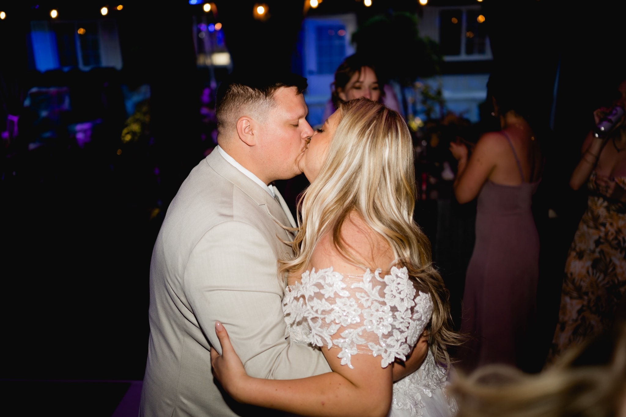 bride and groom kissing on the dance floor