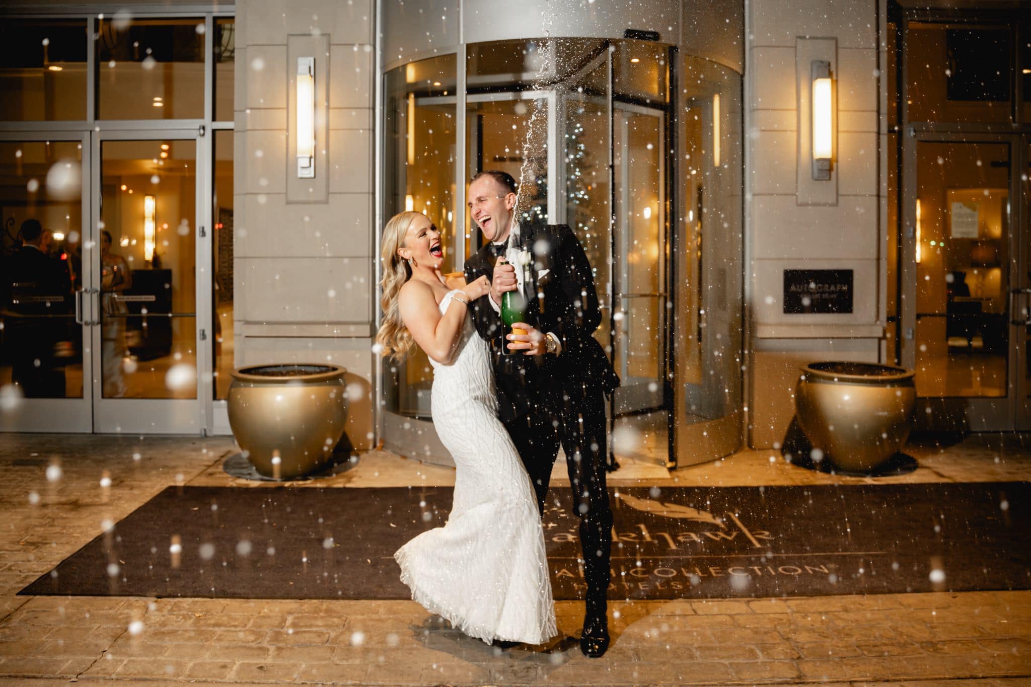 bride and groom popping champagne at hotel blackhawk